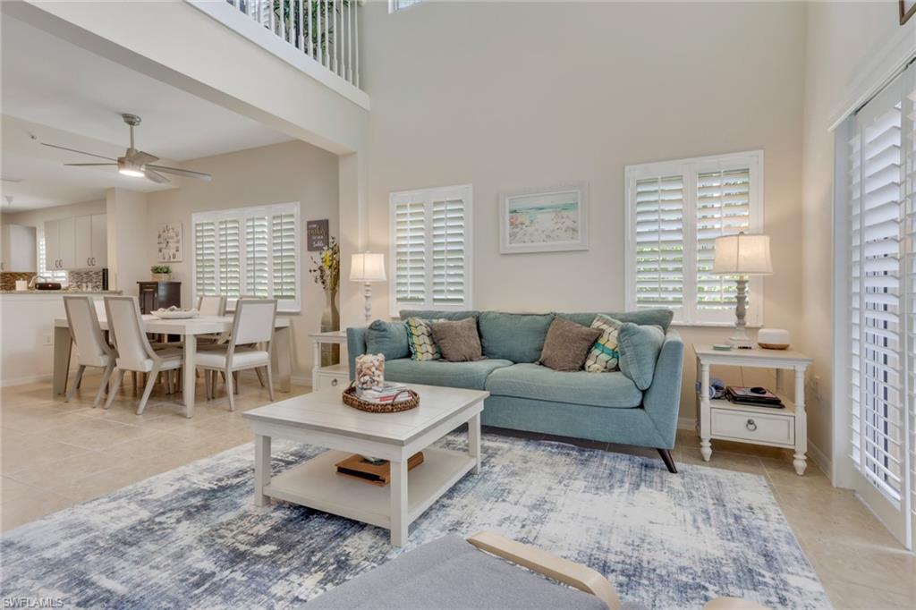 4500 Botanical Pl Circle, Unit 101 Naples, FL 34112 - Photo 7 of 44 a living room with furniture and wooden floor