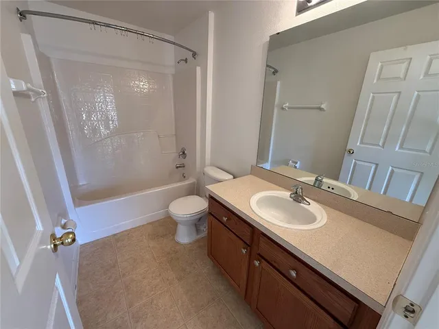 a bathroom with 2 sink tub and a window