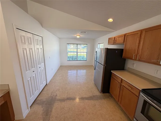 a kitchen with refrigerator and window