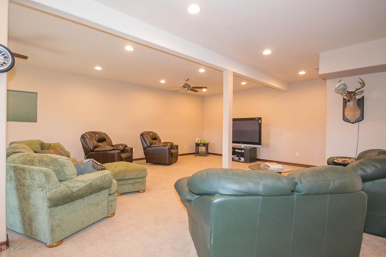 10600 Occidental Road Yakima, WA 98903 - Photo 18 of 40 a living room with furniture and a flat screen tv