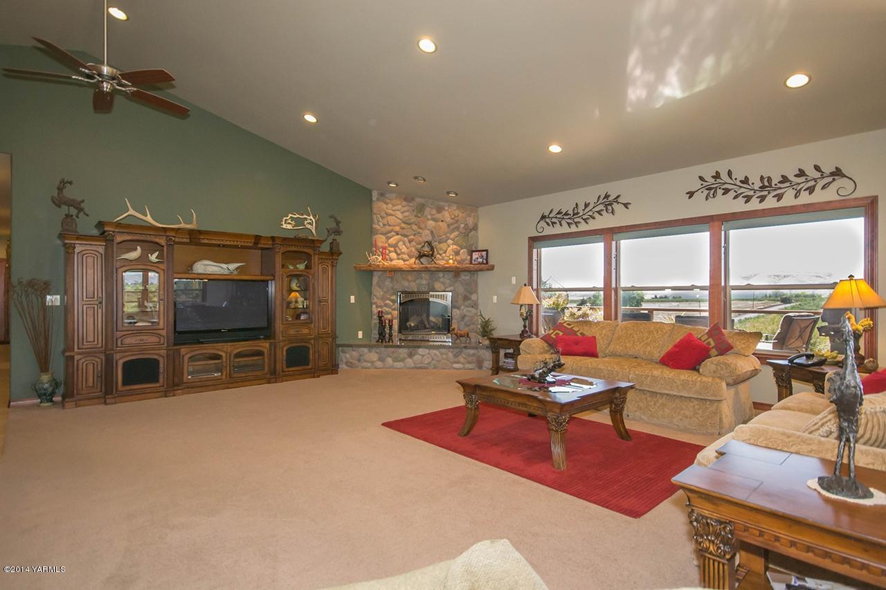 10600 Occidental Road Yakima, WA 98903 - Photo 9 of 40 a living room with furniture a flat screen tv and floor to ceiling window