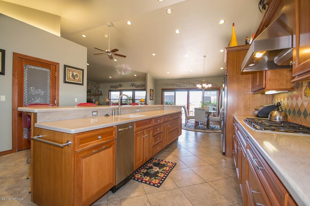 10600 Occidental Road Yakima, WA 98903 - Photo 10 of 40 a kitchen with a stove a sink and a refrigerator