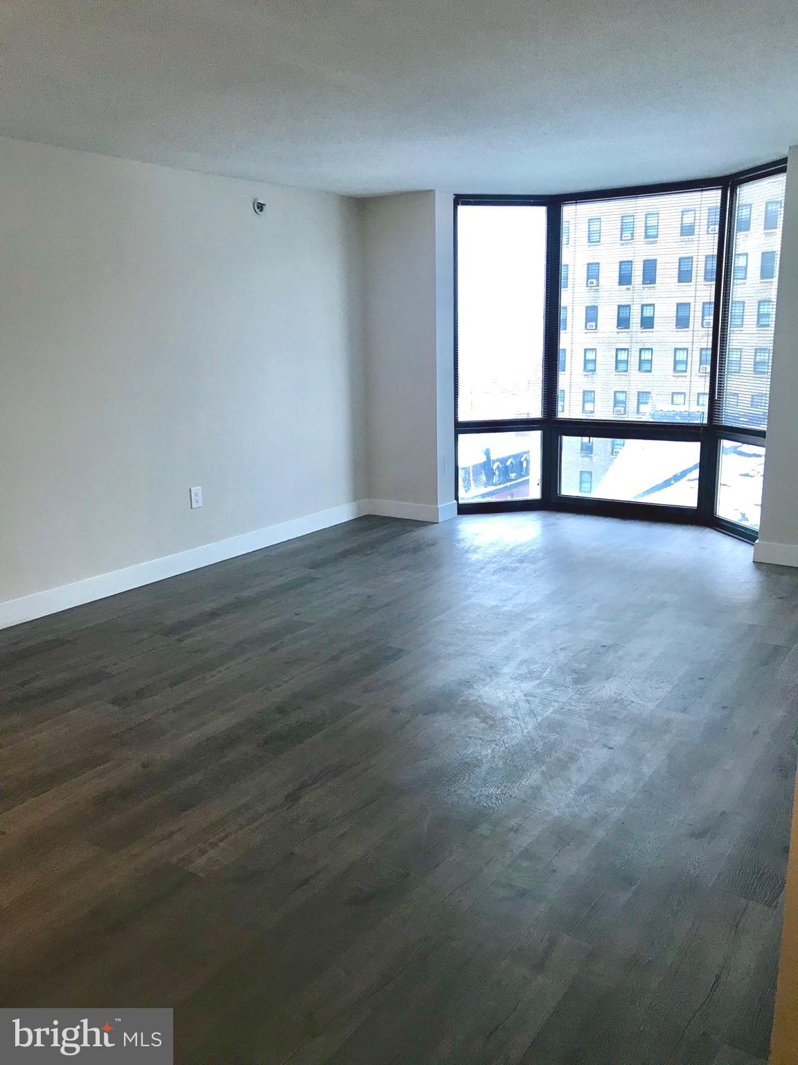 2020 Walnut Street, Unit 10J Philadelphia, PA 19103 - Photo 2 of 18 wooden floor in an empty room with a window