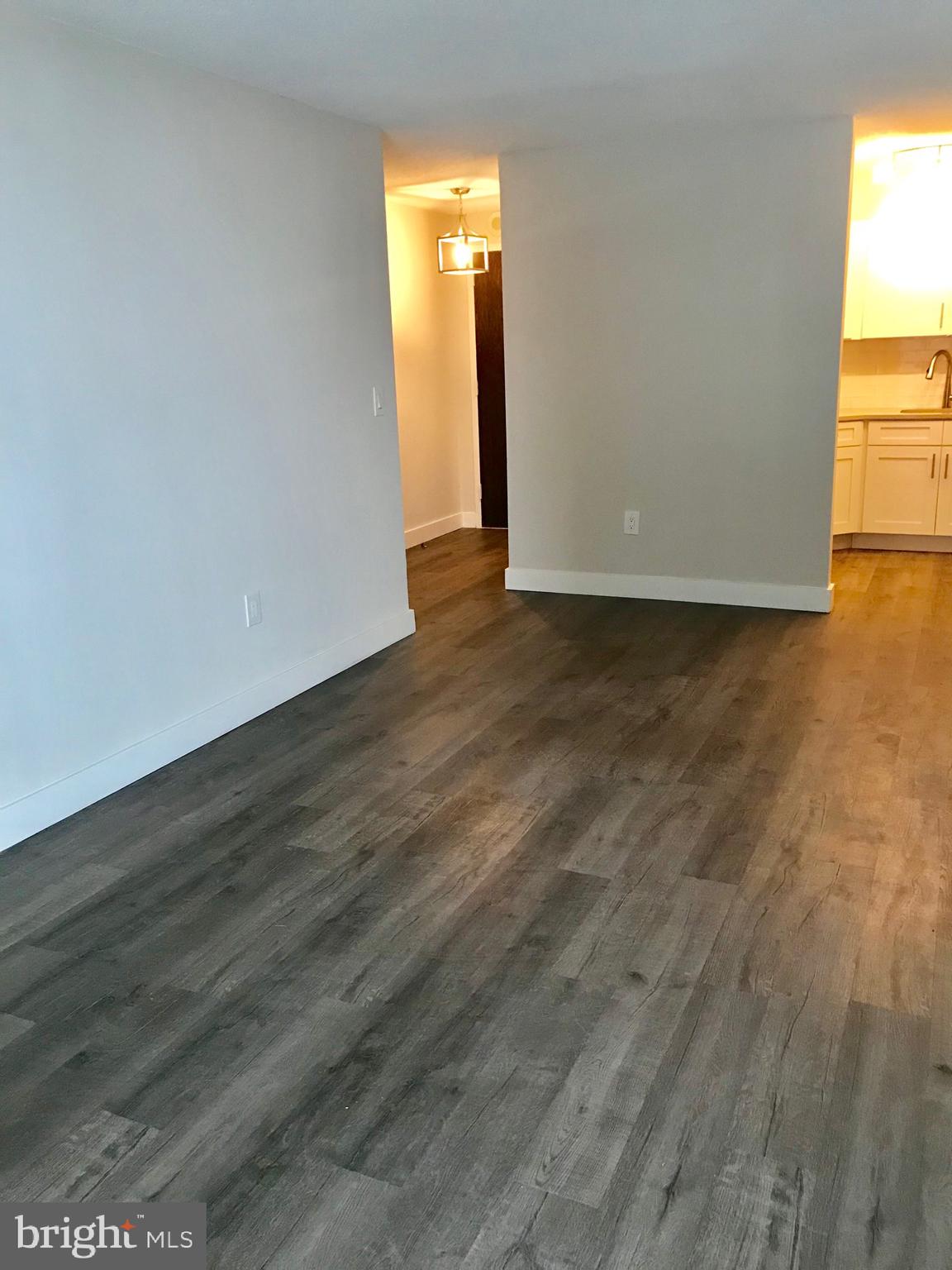 2020 Walnut Street, Unit 10J Philadelphia, PA 19103 - Photo 3 of 18 a view of empty room with wooden floor and fan