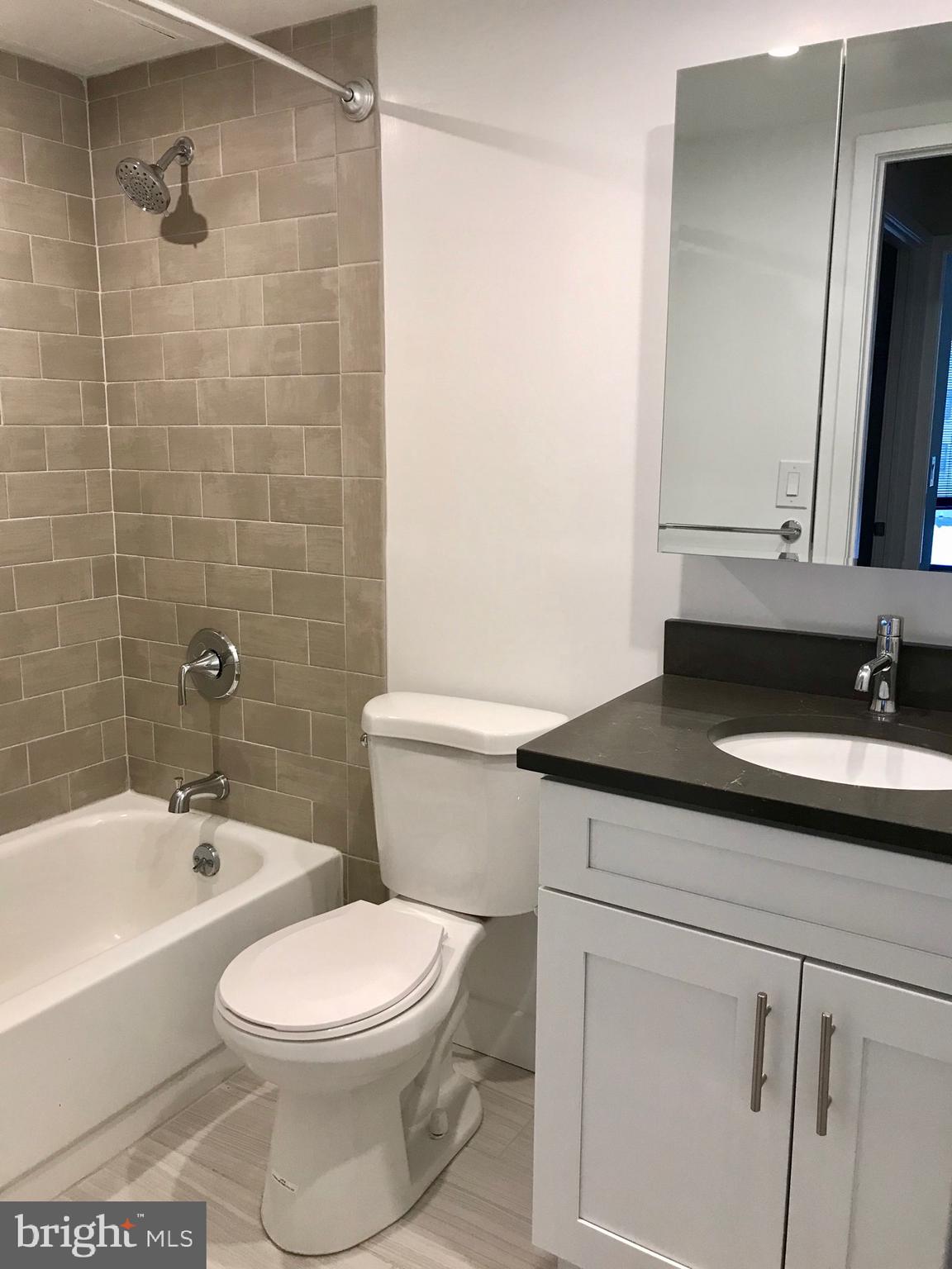 2020 Walnut Street, Unit 10J Philadelphia, PA 19103 - Photo 8 of 18 a bathroom with a sink a toilet and shower