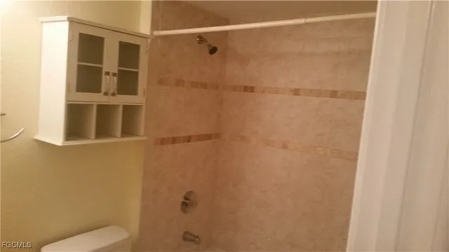 a bathroom with a shower and toilet