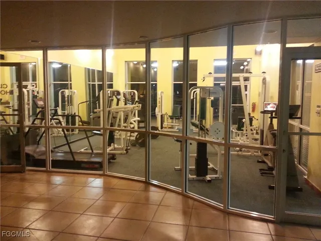 a view of a bathroom with a glass door shower and chairs