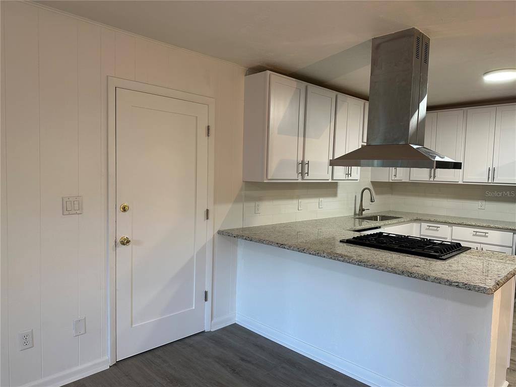 6002 Northwest 33 Street Gainesville, FL 32653 - Photo 11 of 29 a kitchen with granite countertop a sink a stove and cabinets