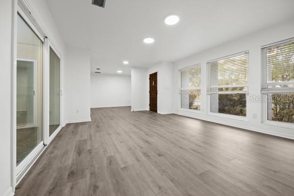 6002 Northwest 33 Street Gainesville, FL 32653 - Photo 18 of 29 an empty room with wooden floor and windows