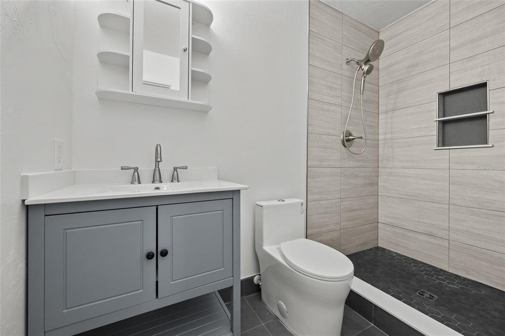 6002 Northwest 33 Street Gainesville, FL 32653 - Photo 20 of 29 a bathroom with a sink a toilet and shower