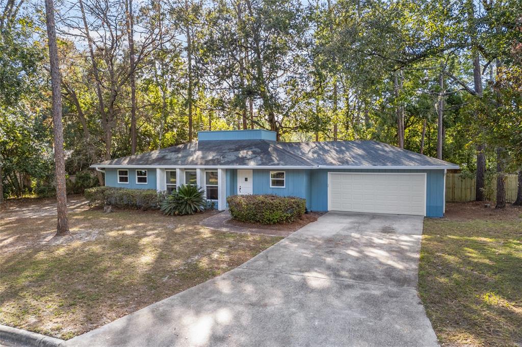 6002 Northwest 33 Street Gainesville, FL 32653 - Photo 2 of 29 a front view of a house with garden