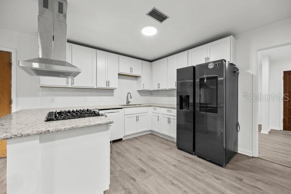 6002 Northwest 33 Street Gainesville, FL 32653 - Photo 4 of 29 a kitchen with a refrigerator sink and cabinets