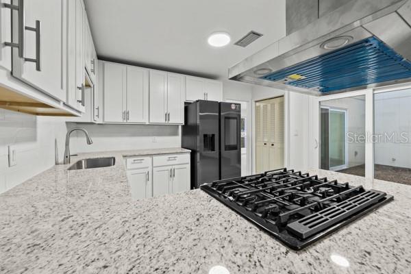 6002 Northwest 33 Street Gainesville, FL 32653 - Photo 5 of 29 a kitchen with stainless steel appliances granite countertop a stove a refrigerator and a sink