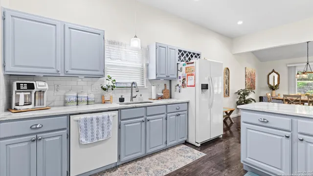 a kitchen with cabinets and window