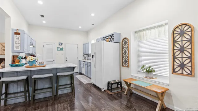 a dining room with furniture and wooden floor