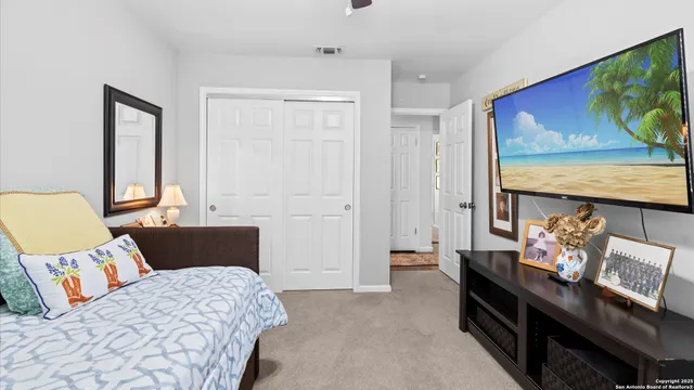 a bedroom with furniture and flat screen tv
