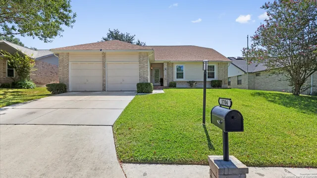 a view of a house with a yard and tree s