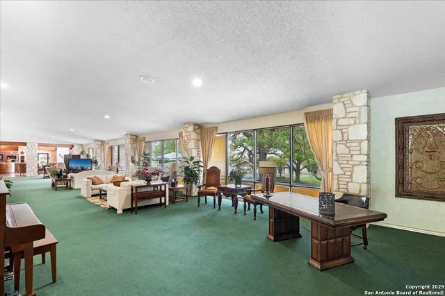 a view of a room with stainless steel appliances a chandelier