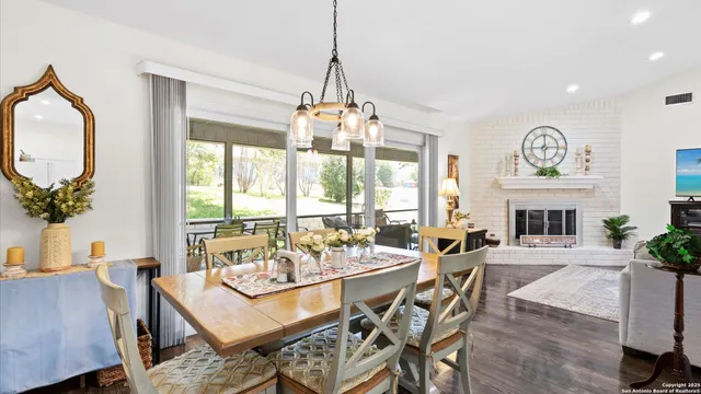 a dining room with furniture window and wooden floor