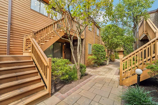 a view of a pathway of a house with wooden stairs