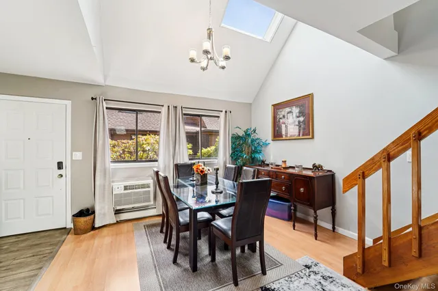 a view of a dining room with furniture and chandelier