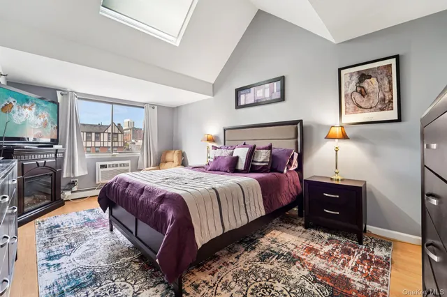 a bedroom with a bed and a television