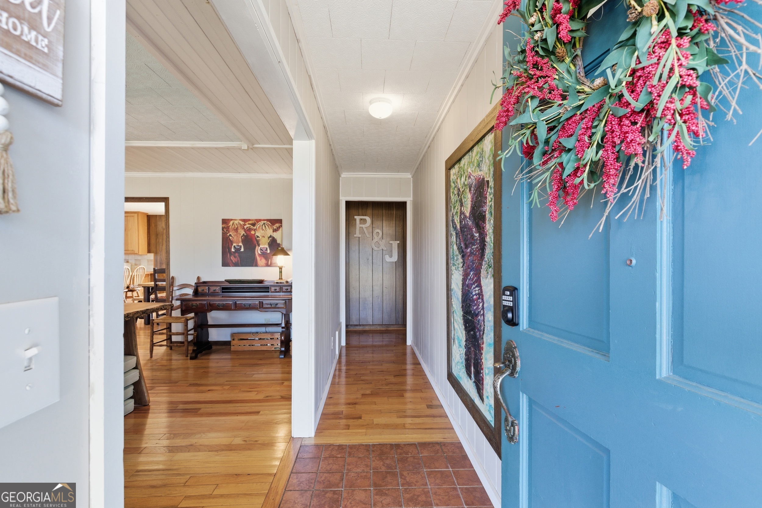 190 Legendary Lane Rabun Gap, GA 30568 - Photo 15 of 47 a hallway with beautiful frames and flower vase