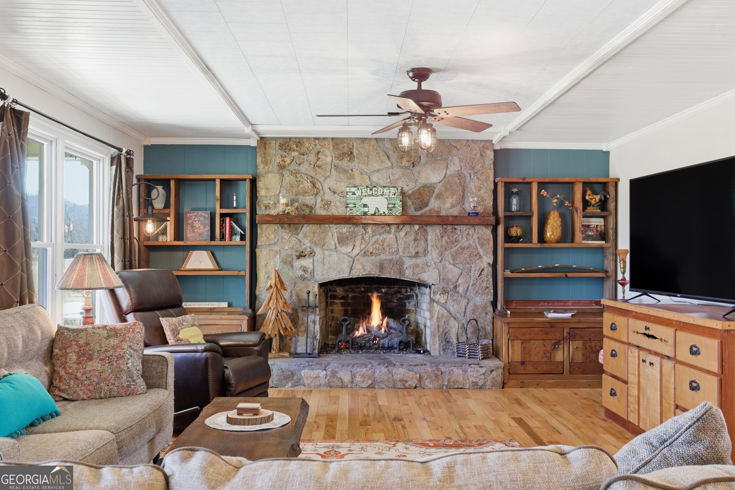190 Legendary Lane Rabun Gap, GA 30568 - Photo 17 of 47 a living room with furniture a flat screen tv and a fireplace