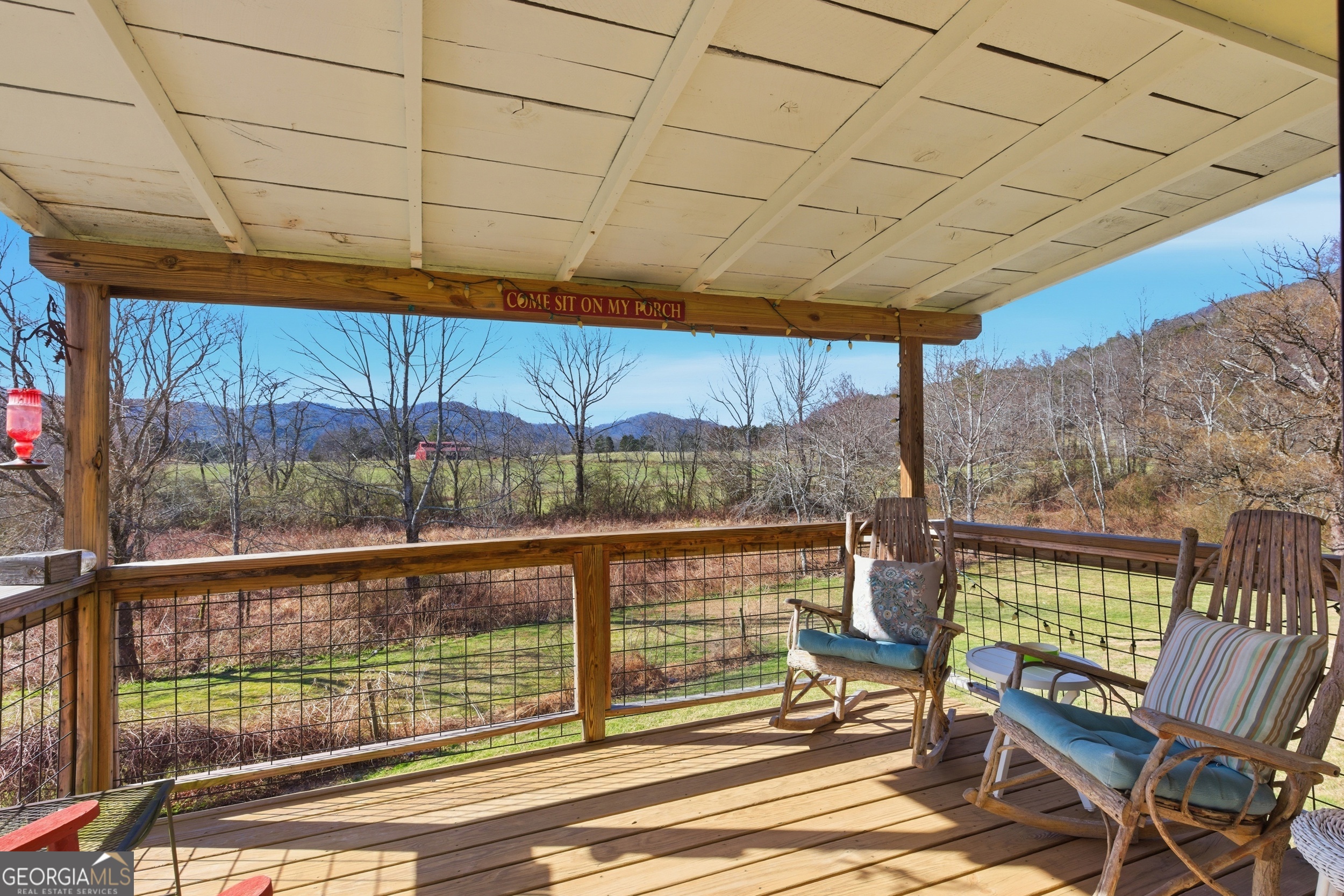190 Legendary Lane Rabun Gap, GA 30568 - Photo 22 of 47 a view of a patio with a table and chairs under an umbrella