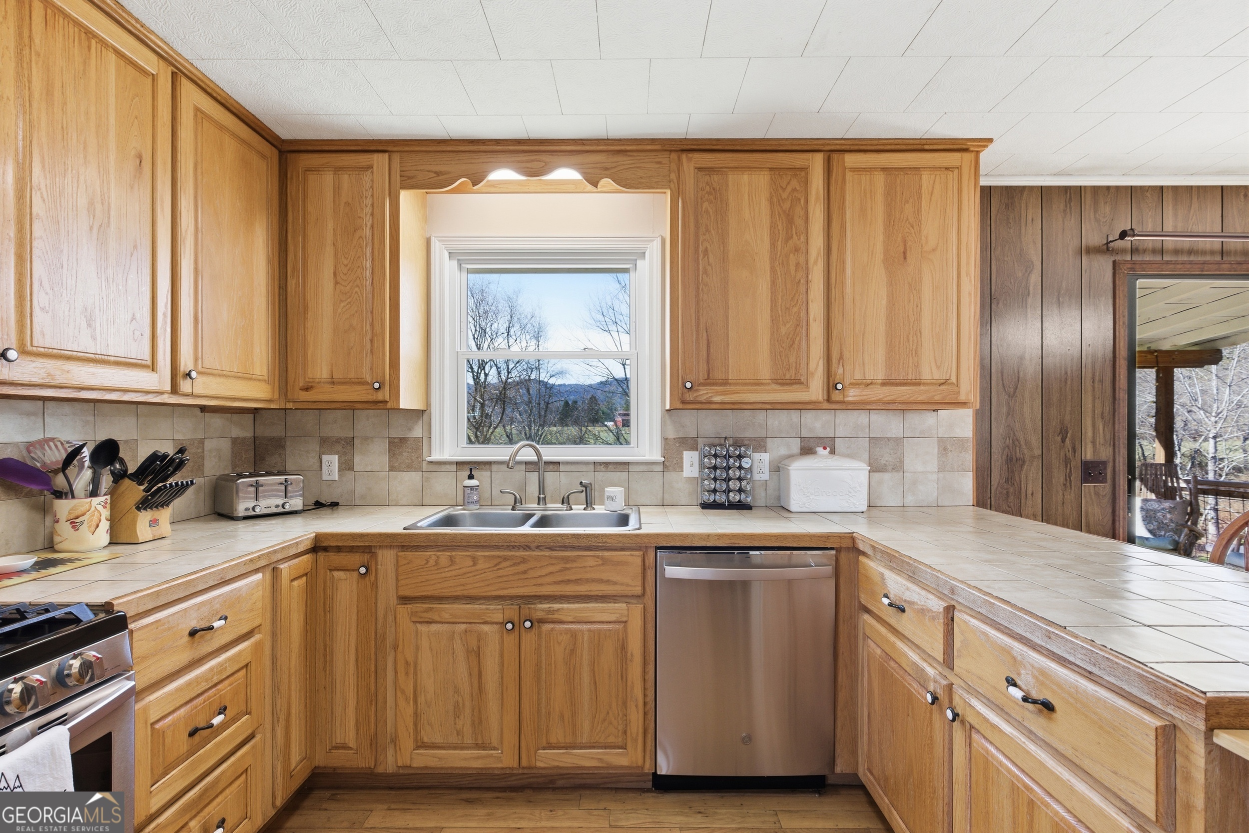 190 Legendary Lane Rabun Gap, GA 30568 - Photo 27 of 47 a kitchen with sink cabinets and stainless steel appliances