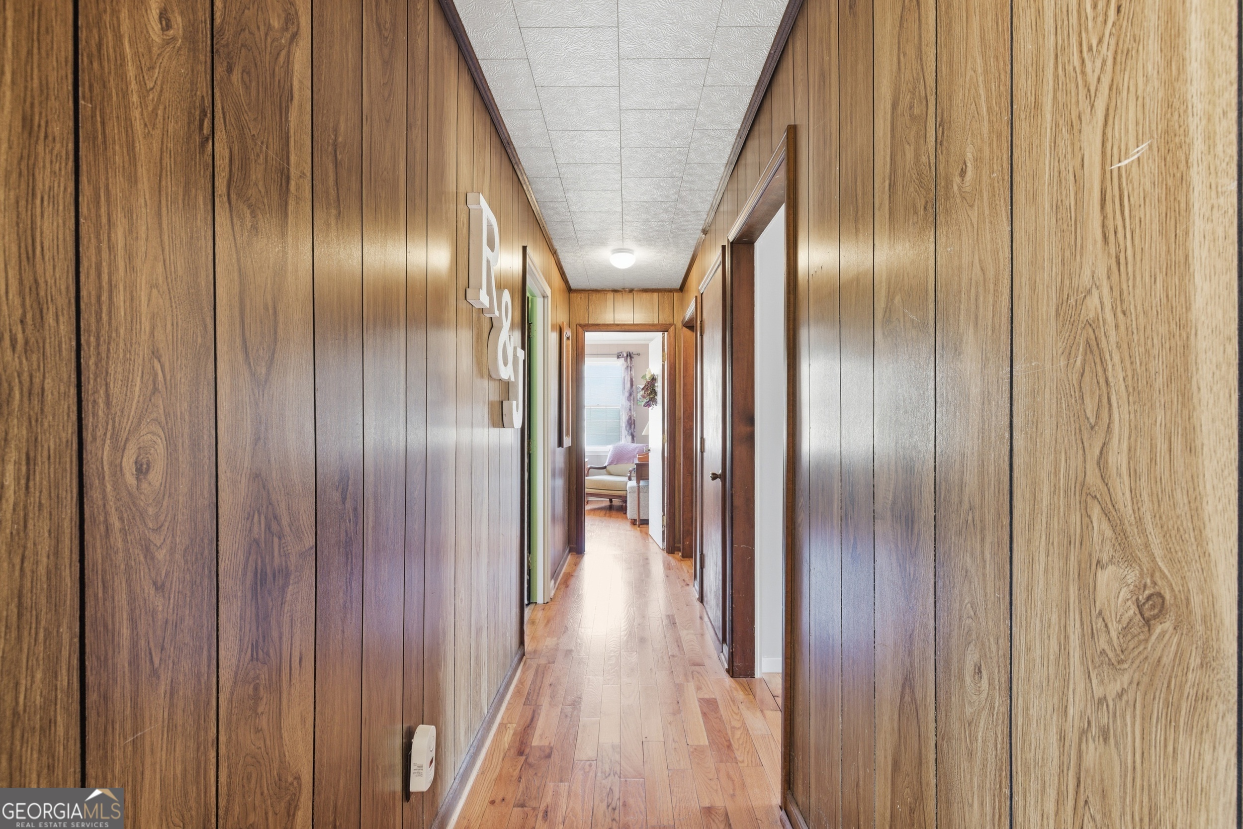 190 Legendary Lane Rabun Gap, GA 30568 - Photo 28 of 47 a hallway with wooden floor stairs and a large window in a patio
