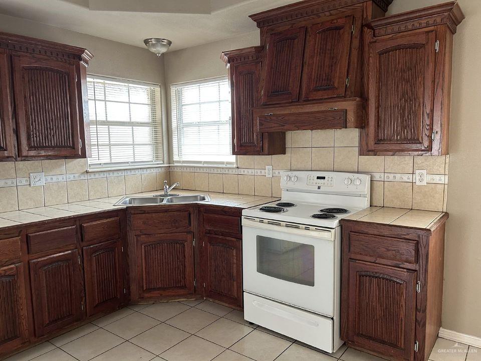 809 West Bronze Drive, Unit 1 Pharr, TX 78577 - Photo 6 of 13 a kitchen with a stove sink and cabinets