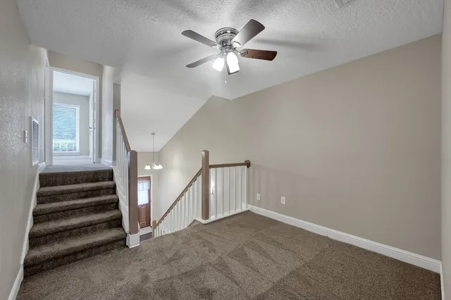 a view of an empty room with a ceiling fan