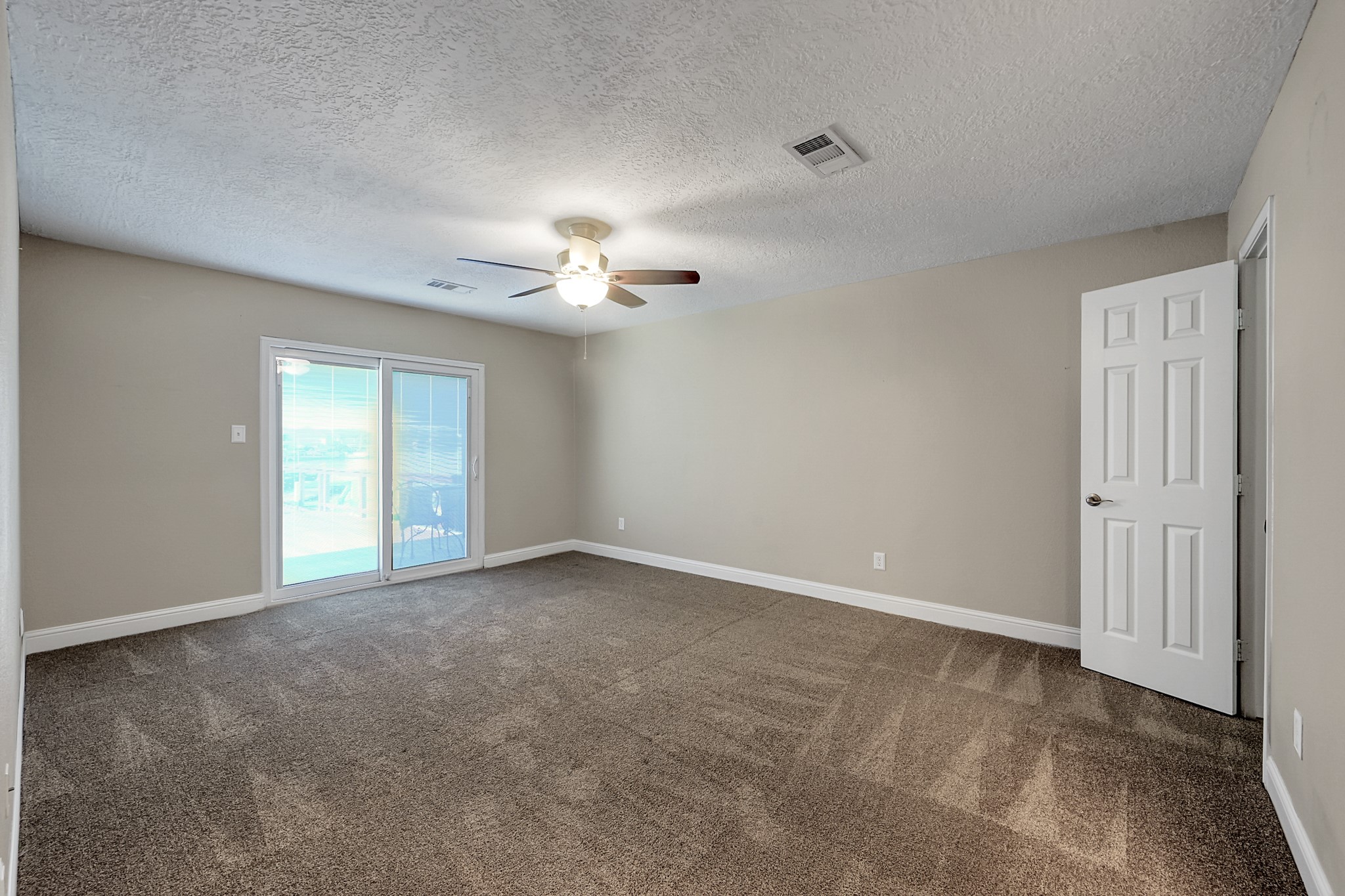 125 Capetown Street Conroe, TX 77356 - Photo 12 of 23 a view of an empty room with a chandelier fan