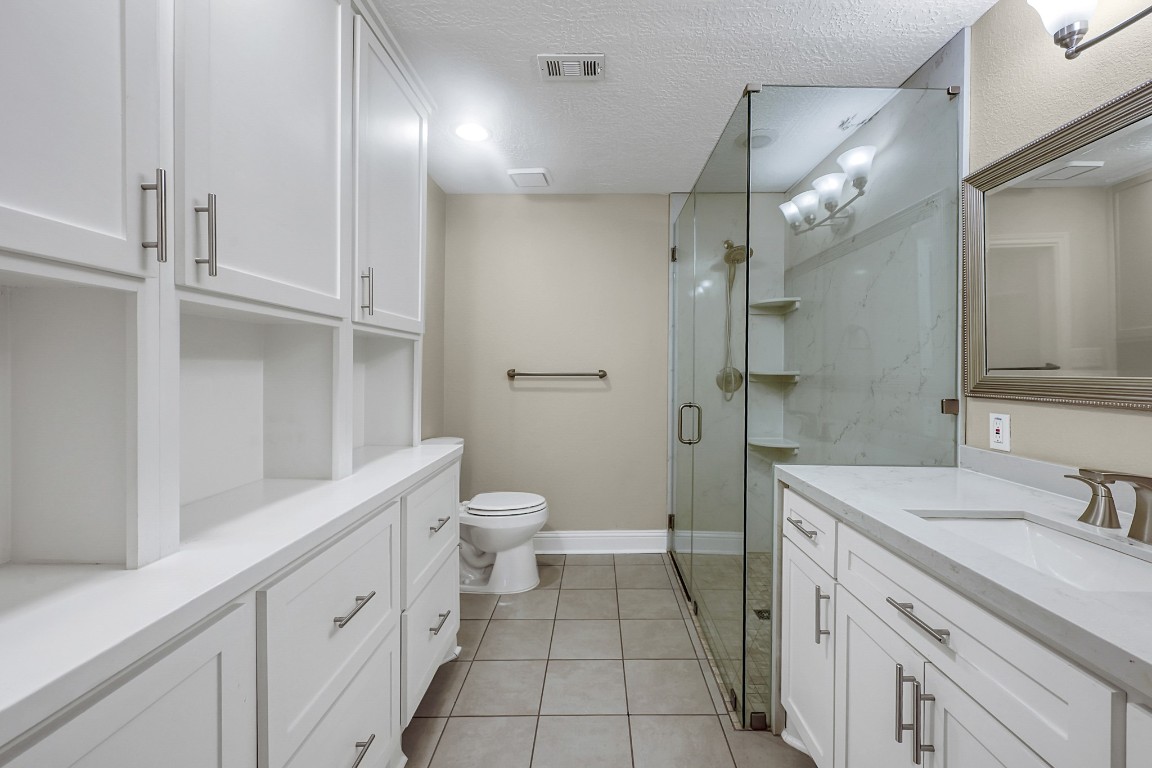 125 Capetown Street Conroe, TX 77356 - Photo 14 of 23 a bathroom with a sink a toilet and shower