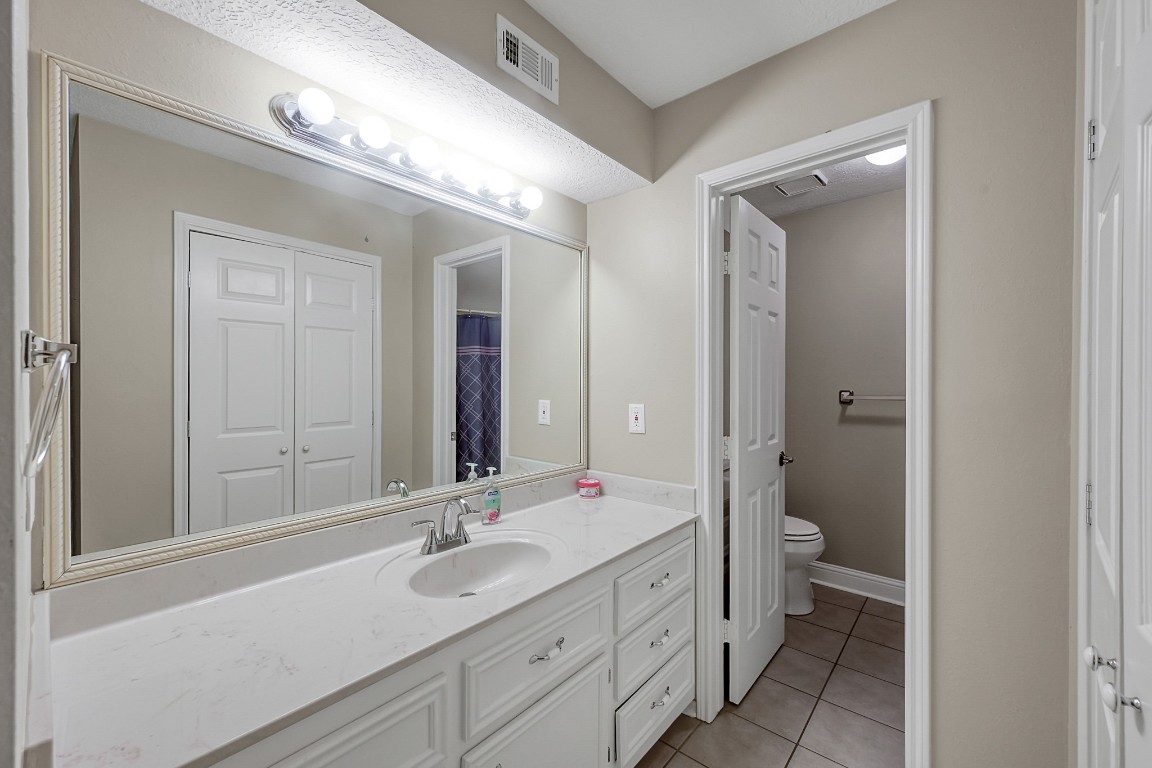 125 Capetown Street Conroe, TX 77356 - Photo 16 of 23 a bathroom with a sink a toilet and a mirror