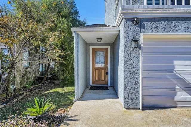 a front view of a house with a garden