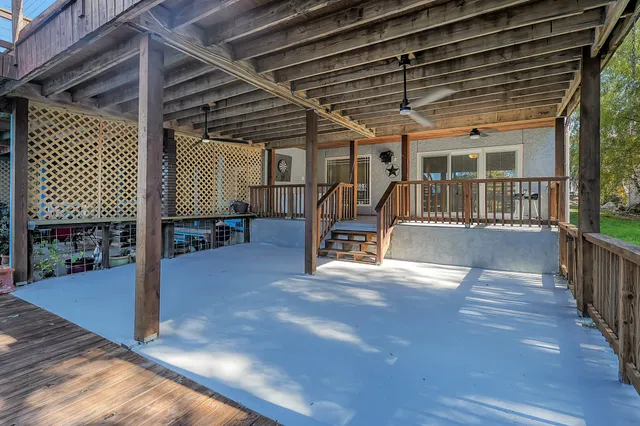 a view of a porch with furniture and floor to ceiling window