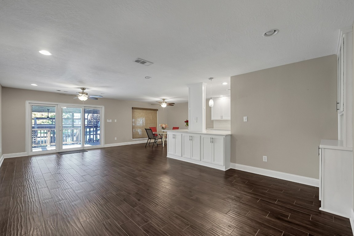 125 Capetown Street Conroe, TX 77356 - Photo 3 of 23 a view of an empty room with wooden floor and a window