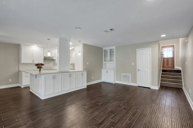 a view of kitchen and wooden floor