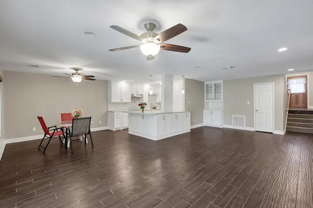 a view of a dining room with furniture and wooden floor