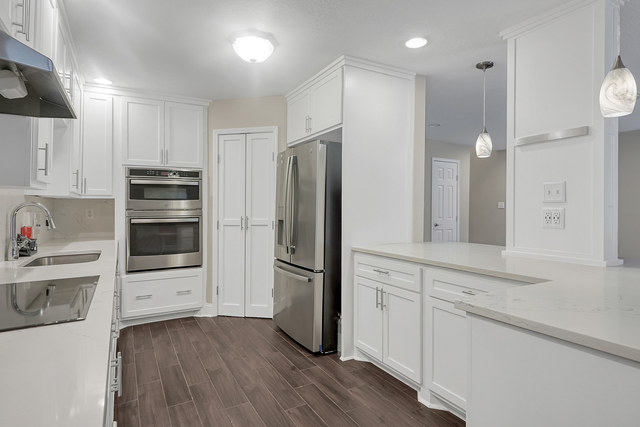 125 Capetown Street Conroe, TX 77356 - Photo 9 of 23 a kitchen with a refrigerator and a stove top oven