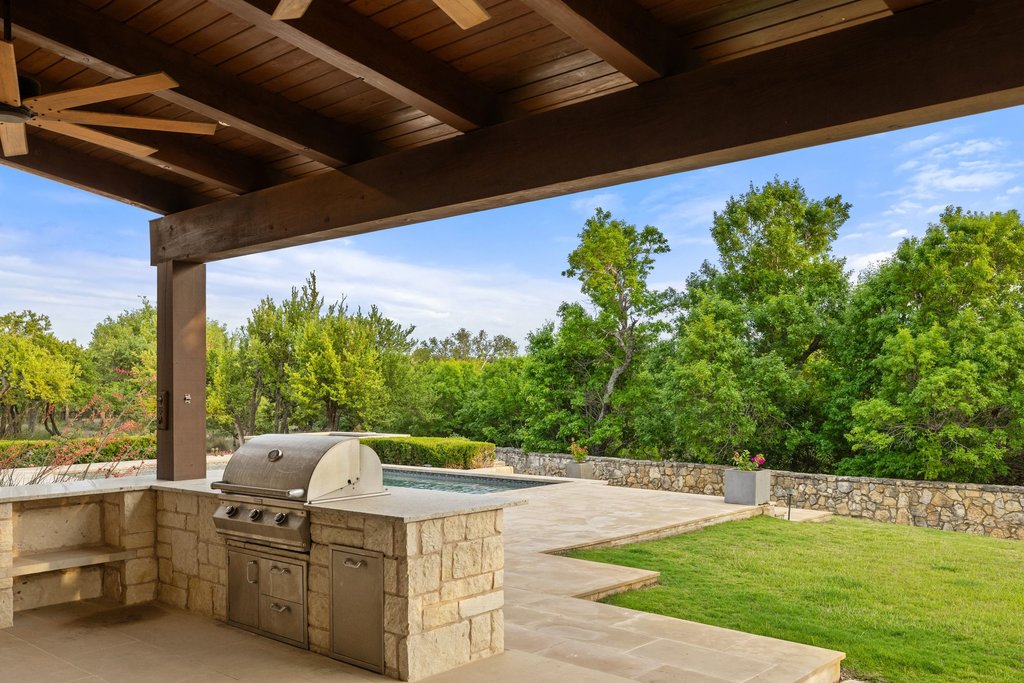 2560 Bell Springs Road Dripping Springs, TX 78620 - Photo 38 of 40 a view of a swimming pool with an outdoor seating and a yard