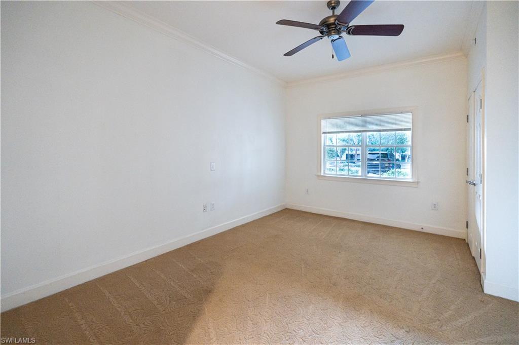 1362 Centre Ct Ridge Drive, Unit 101 Reunion, FL 34747 - Photo 19 of 25 Carpeted spare room featuring ornamental molding and ceiling fan