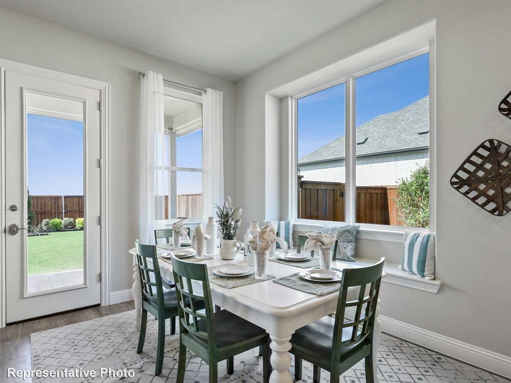 1143 Rothland Lane Red Oak, TX 75154 - Photo 6 of 18 Well-lit dining area featuring a window seat, white trim, and wood-finish flooring