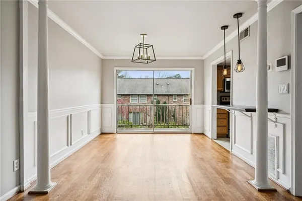 a view of an entryway with wooden floor
