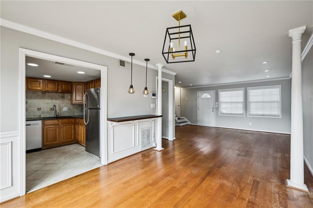 2825 Northeast Expressway, Unit O2 Atlanta, GA 30345 - Photo 13 of 27 a view of a hallway with wooden floor and a kitchen