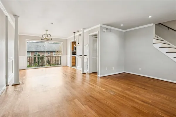 a view of an empty room with a kitchen