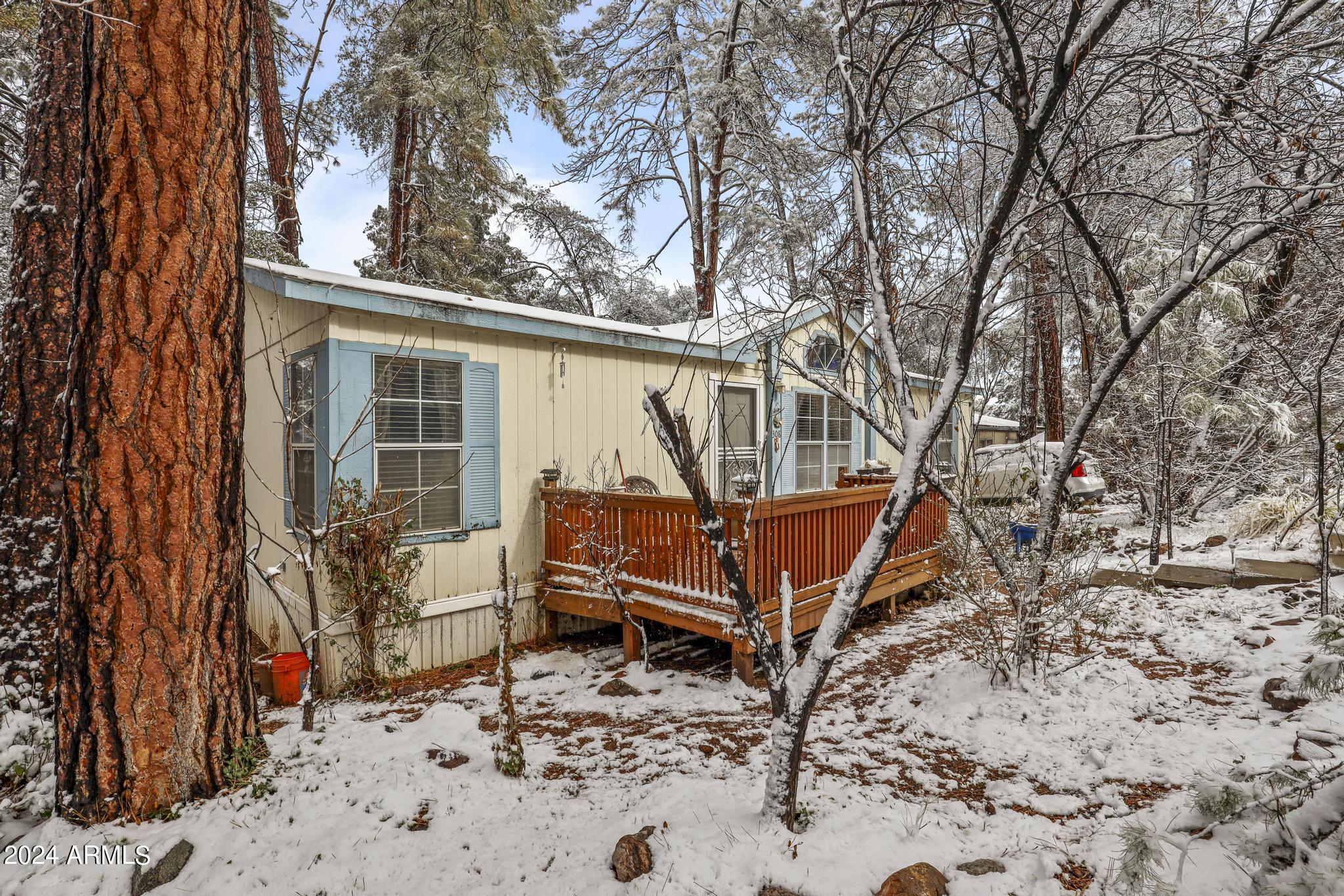 308 East Cherry Street Payson, AZ 85541 - Photo 2 of 22 a wooden bench sitting in front of a house