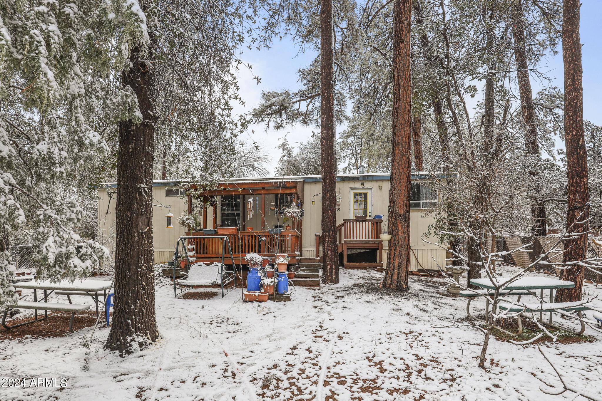 308 East Cherry Street Payson, AZ 85541 - Photo 21 of 22 a view of a backyard with table and chairs couches wooden floor and a large tree